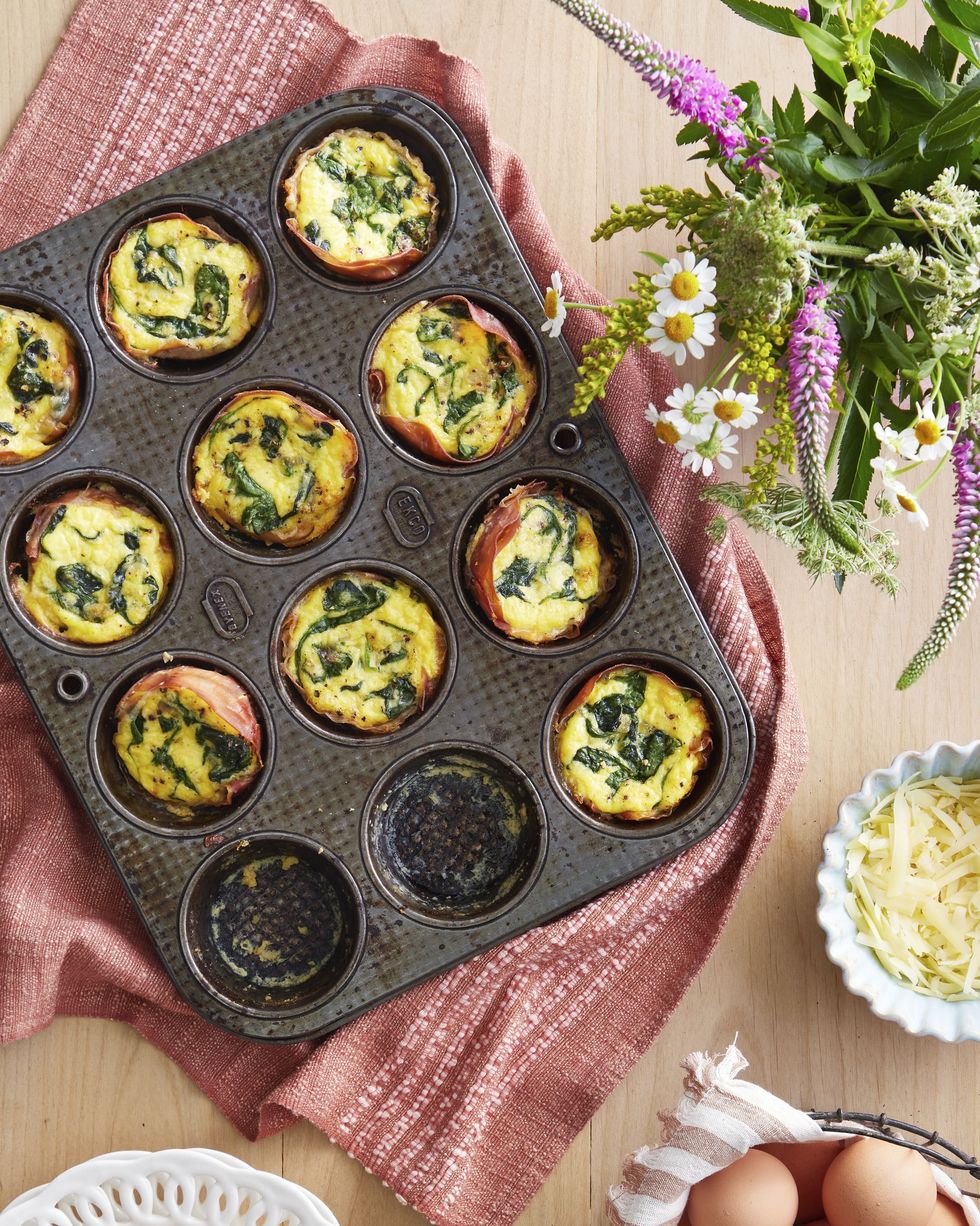 prosciutto egg tarts with spinach and gruyere in a muffin pan