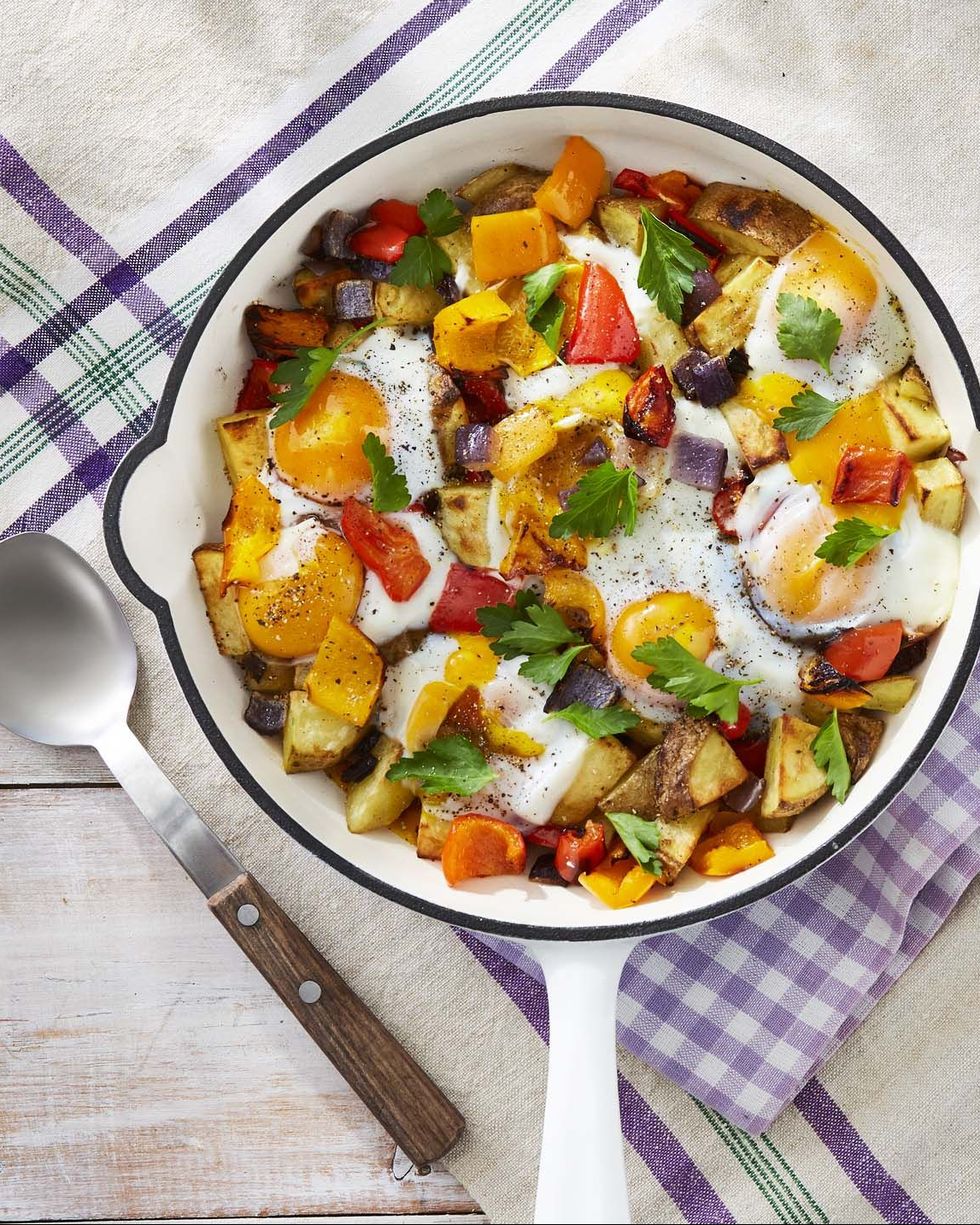 roasted potato and pepper hash in a white enamel cast iron skillet