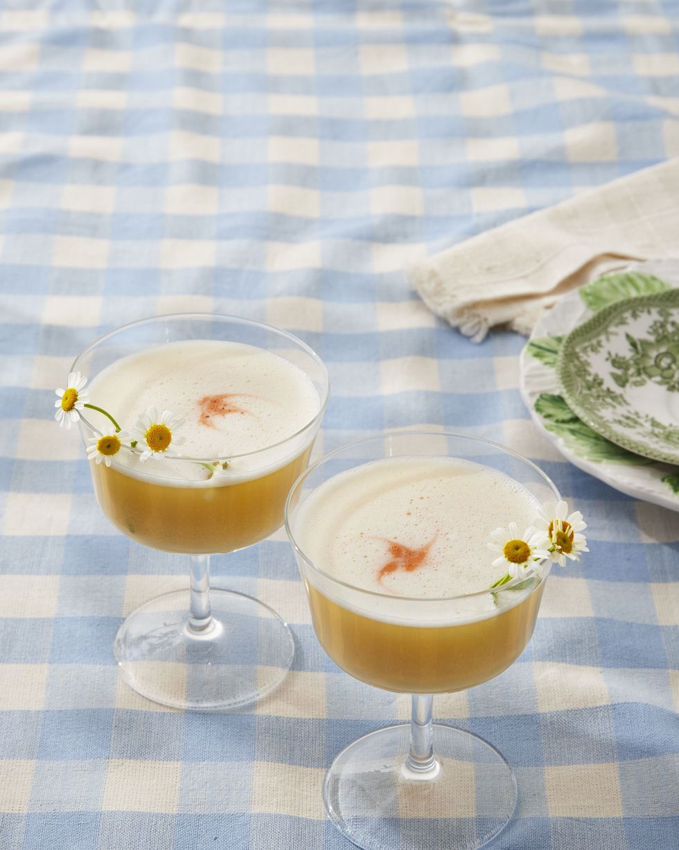 spring gin flip in glasses and garnished with camomile flowers