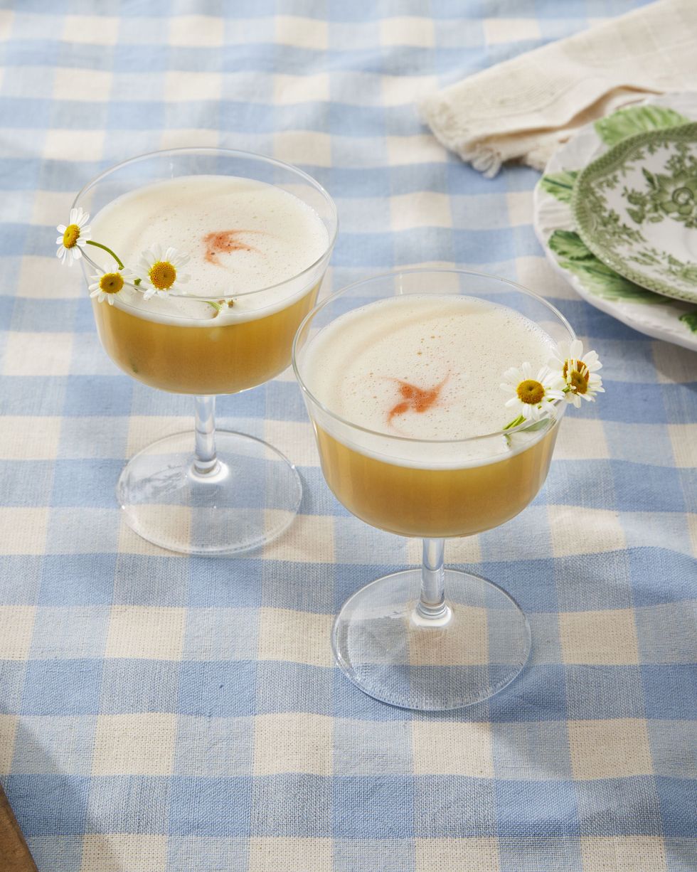 spring gin flip in glasses and garnished with camomile flowers