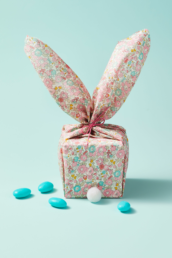easter basket ideas, fabric wrapped box with large bunny shaped ears sticking out at the top