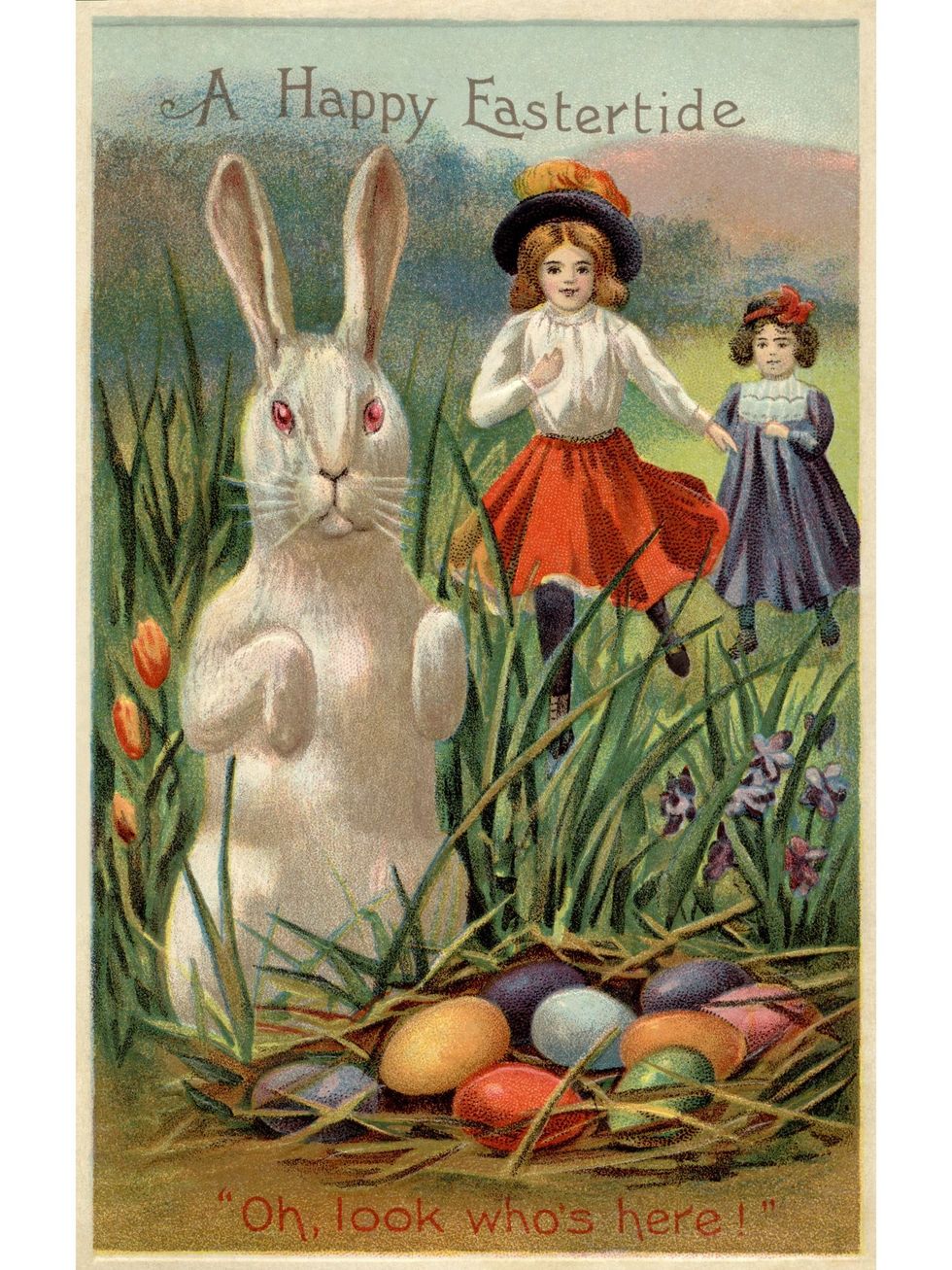 a vintage easter postcard of two girls running towards a rabbit and a nest of colored eggs
