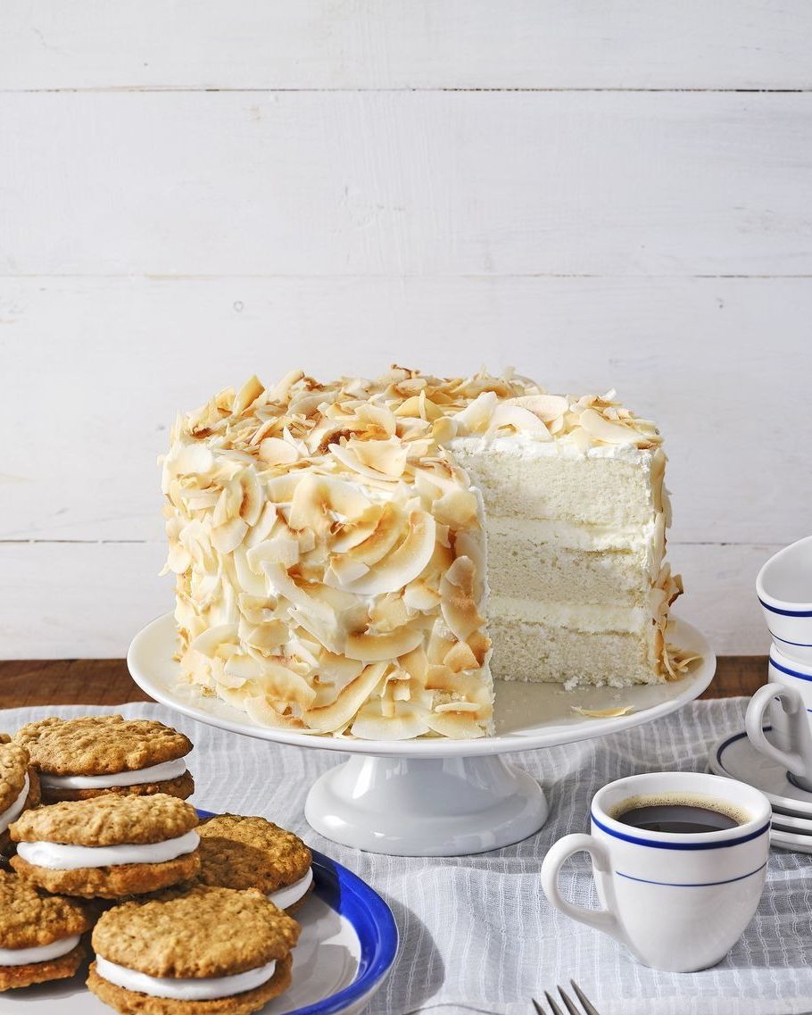 three layer coconut angel cake with toasted coconut all over the outside