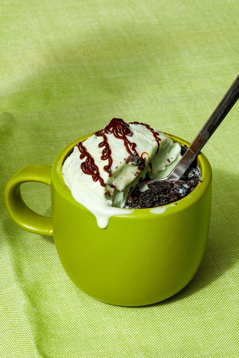 oreo mug cake with mint ice cream and chocolate drizzled on top