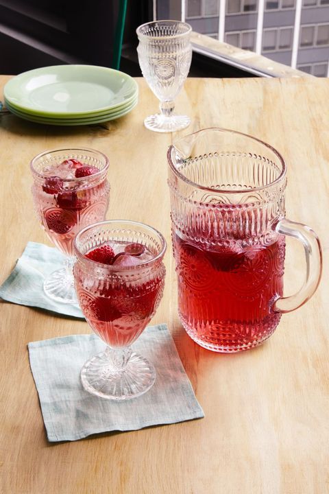 strawberry sangria in pitcher and two glasses
