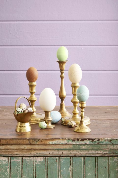 eggs displayed on brass candlesticks