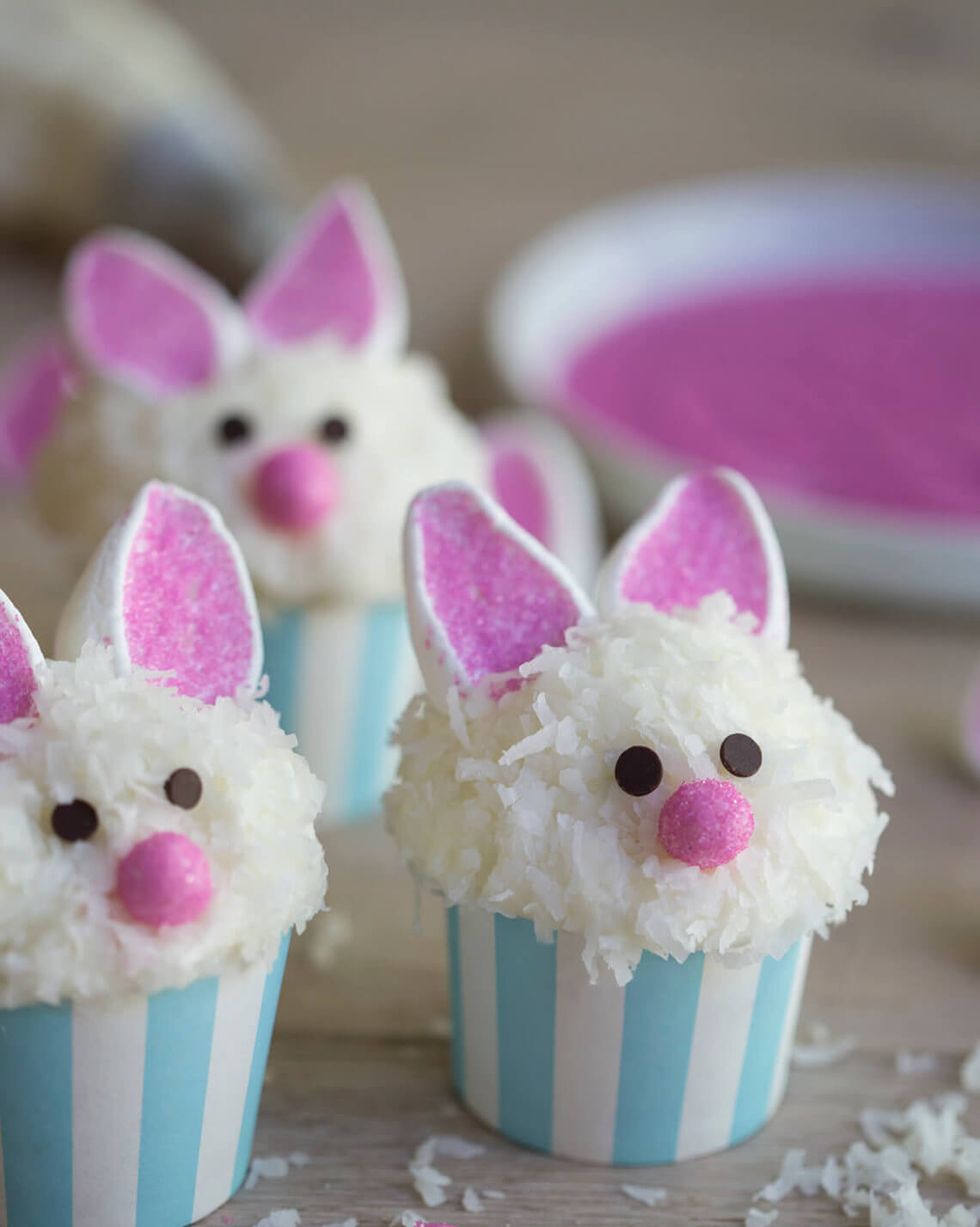 coconut covered cupcakes with chocolate chip eyes and candy nose and marshmallow bunny ears