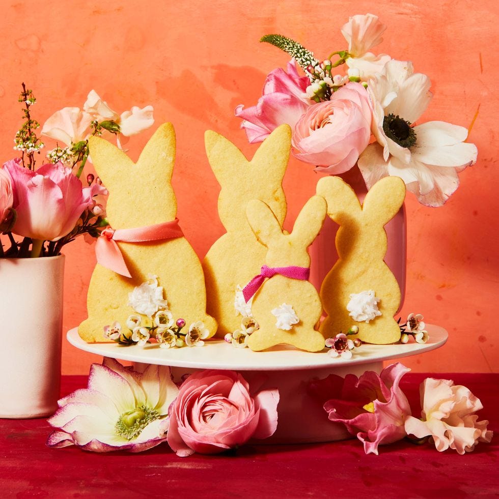 bunny cookies with flowers on a cake stand