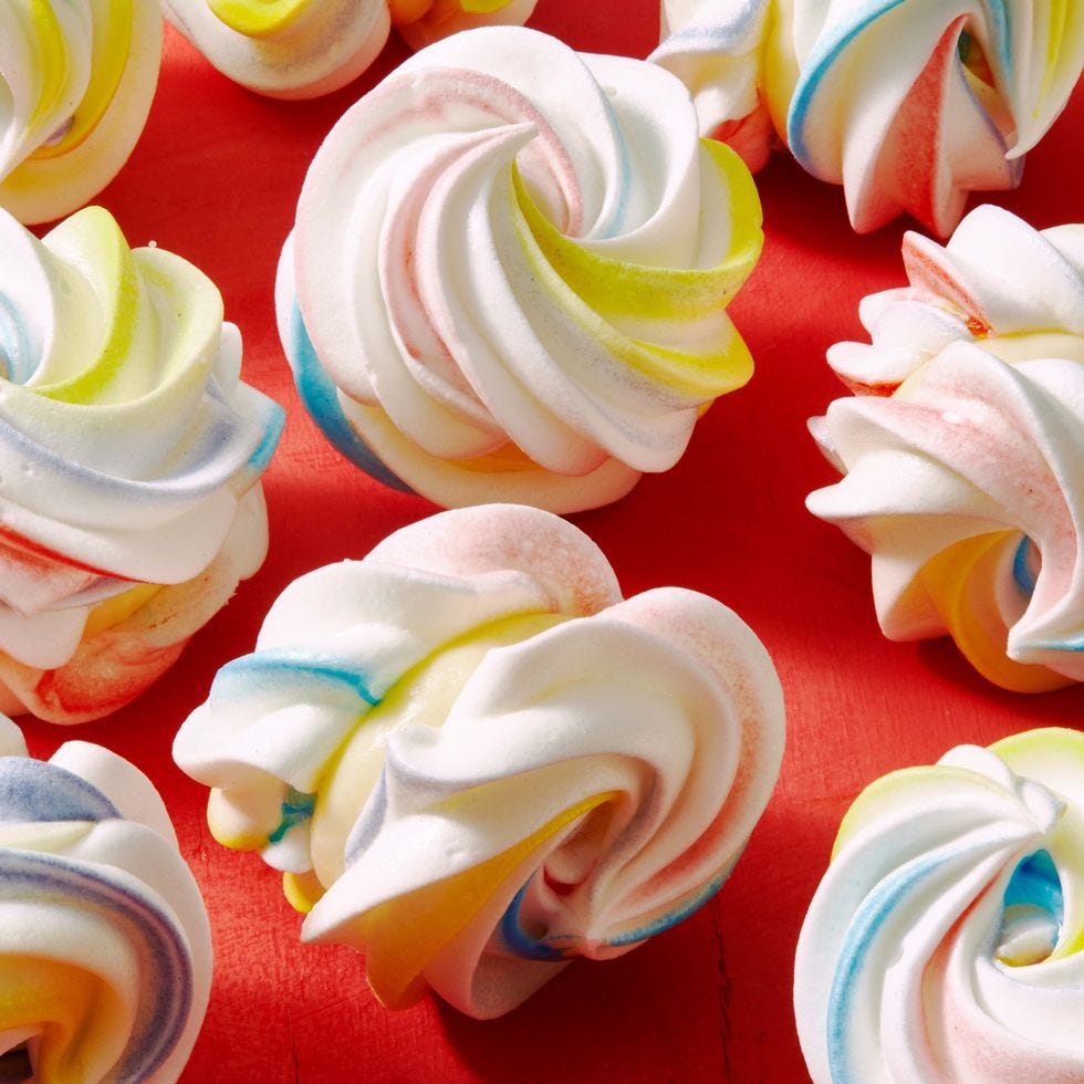 a close up of rainbow meringue sandwiches easter desserts