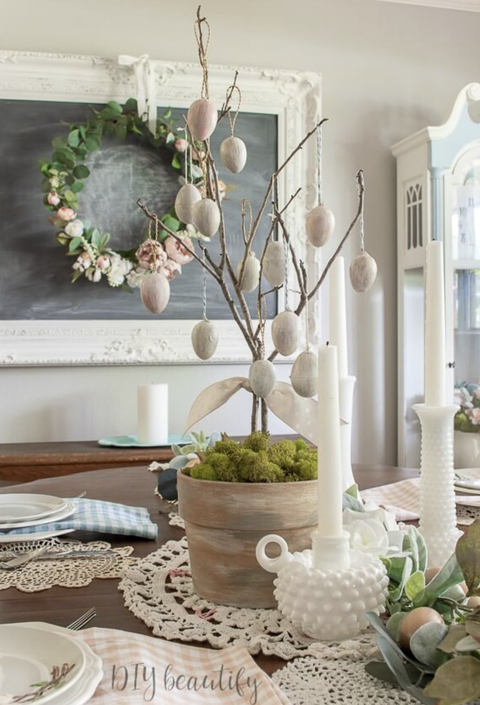 easter egg ideas antiqued eggs hanging from branches on the table