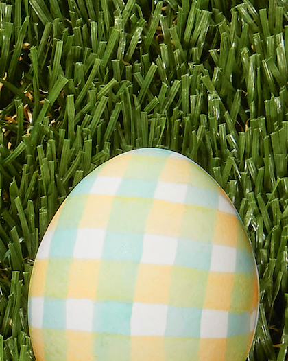 pastel yellow and green gingham design painted on a white easter egg for a simple decoration