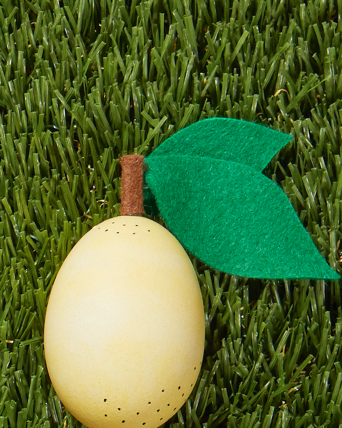 pale yellow lemon easter egg design decorated with green felt leaf cutouts
