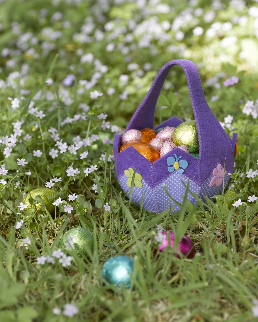 basket of easter eggs in grass