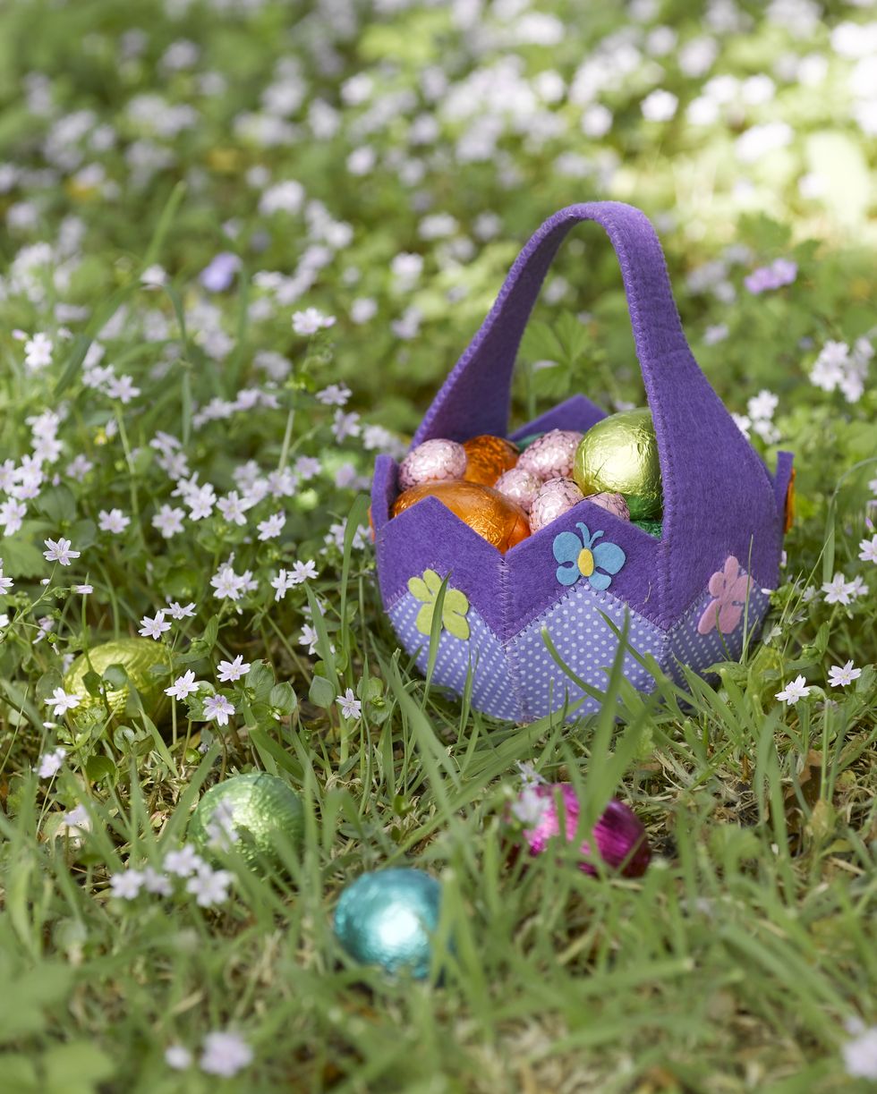 basket of easter eggs in grass