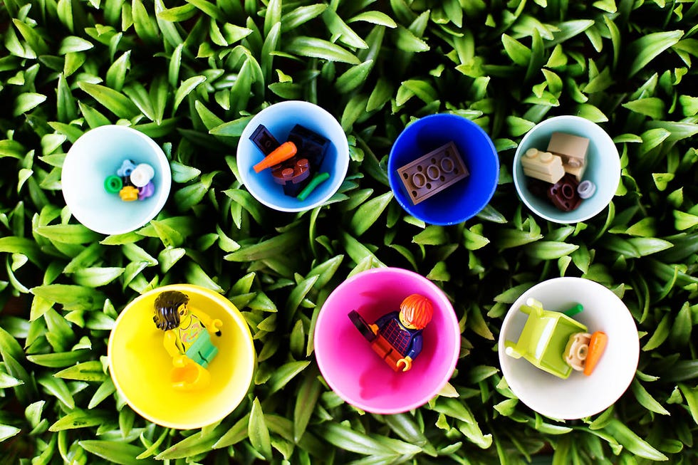 easter egg hunt ideas, legos in colorful cups in the grass