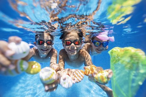 summer easter in swimming pool kids are playing in water and having fun with easter eggs
nikon d850