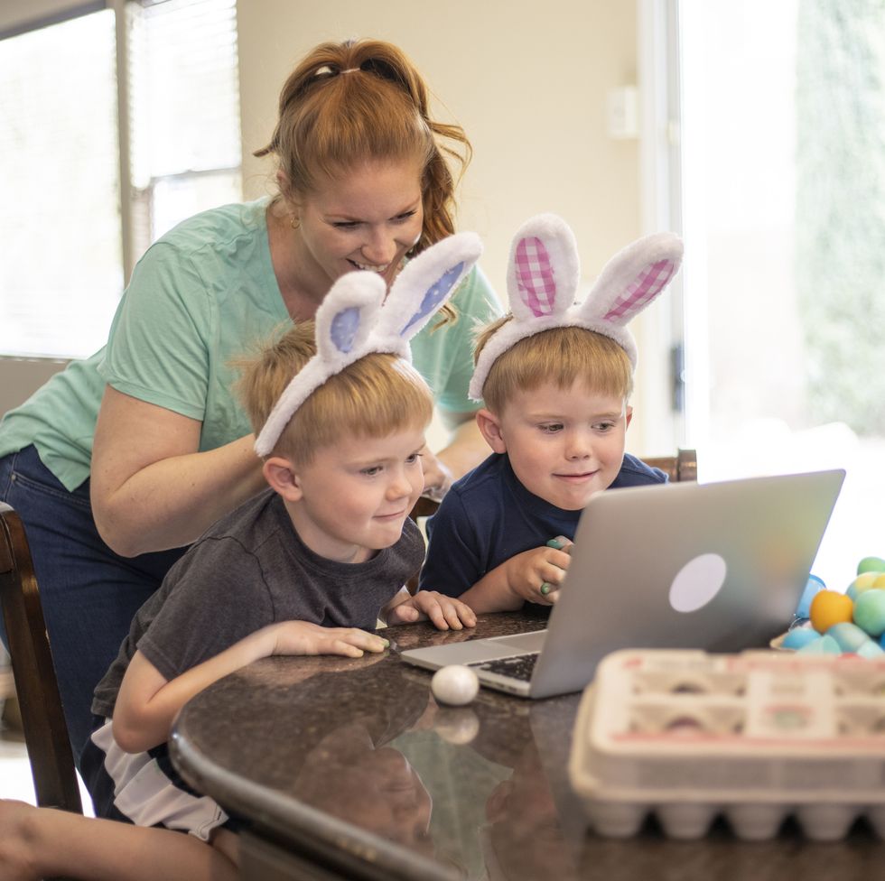 a family celebrating easter while social distancing using a laptop to talk to friends and family