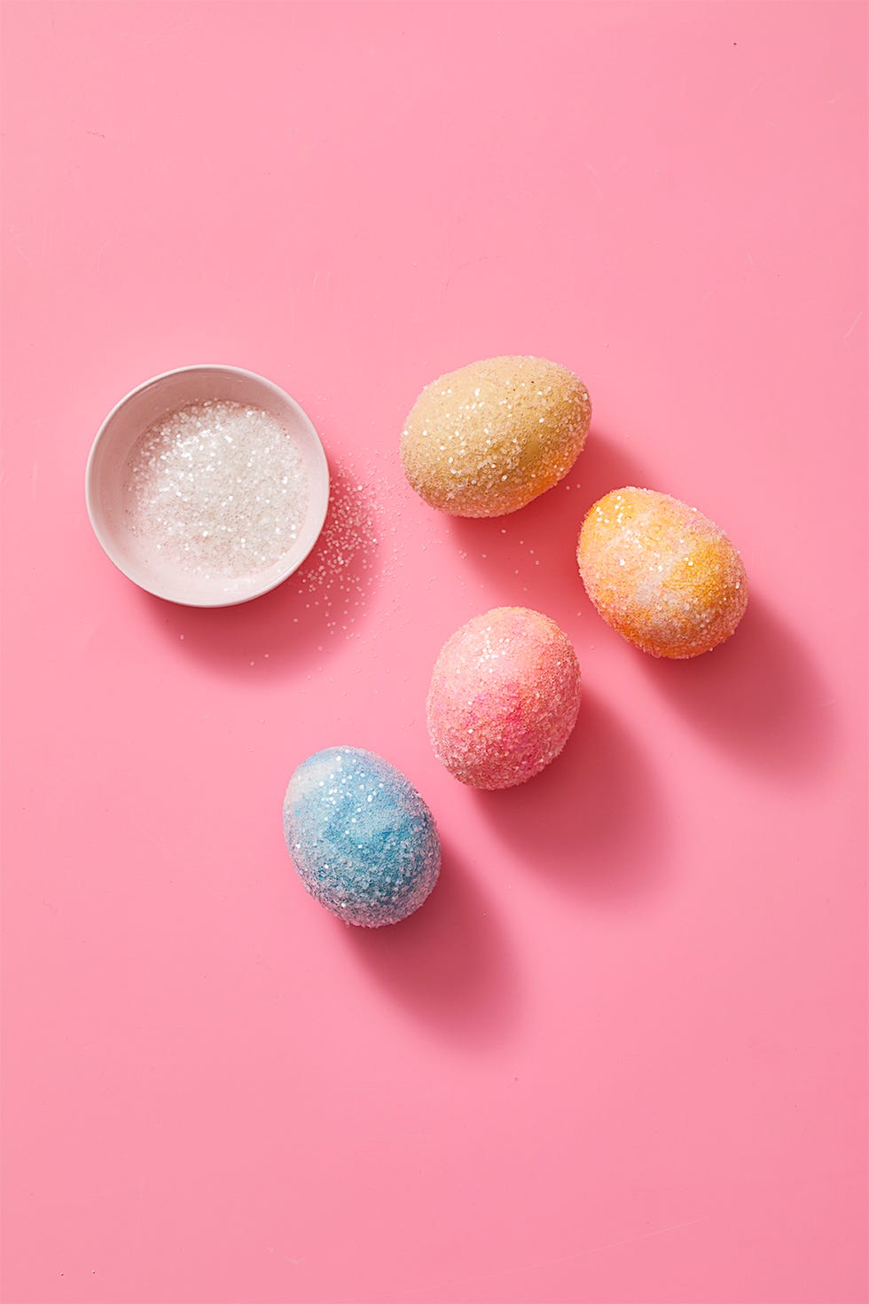easter egg ideas, colorful easter eggs sprinkled with sugar next to a bowl of sugar