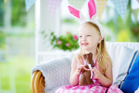 Easter Facts Happy Girl Eating Chocolate Bunny