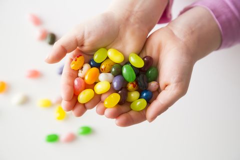Easter Facts Hands Holding Jellybeans White Background