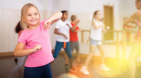 girl exercising in group during dance class