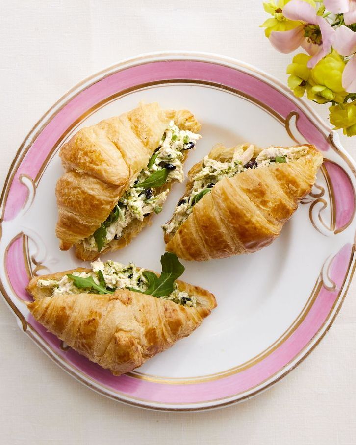 pesto chicken salad croissants on white and pink plate