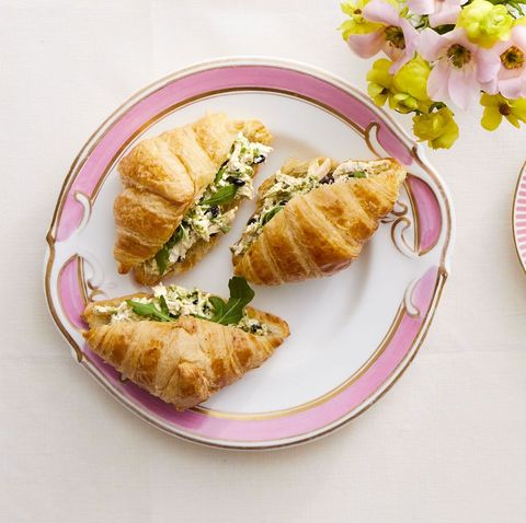 pesto chicken salad croissants on white and pink plate