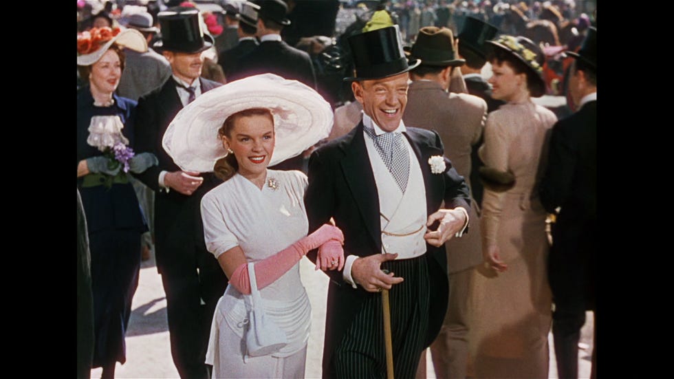 judy garland and fred astaire happily walk down a street wearing fine clothes in scene from easter parade , a good housekeeping pick for best easter movies for kids