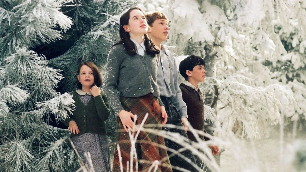 the pevensie children look at narnia with wonder in a scene from the chronicles of narnia the lion, the witch and the wardrobe , a good housekeeping pick for best easter movies for kids