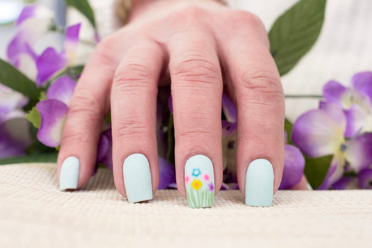 spring flowers nail art design on a womans hands