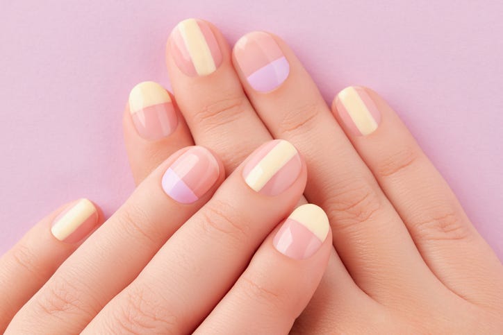 beautiful females hands with manicure on lilac background trendy minimal spring summer nail design