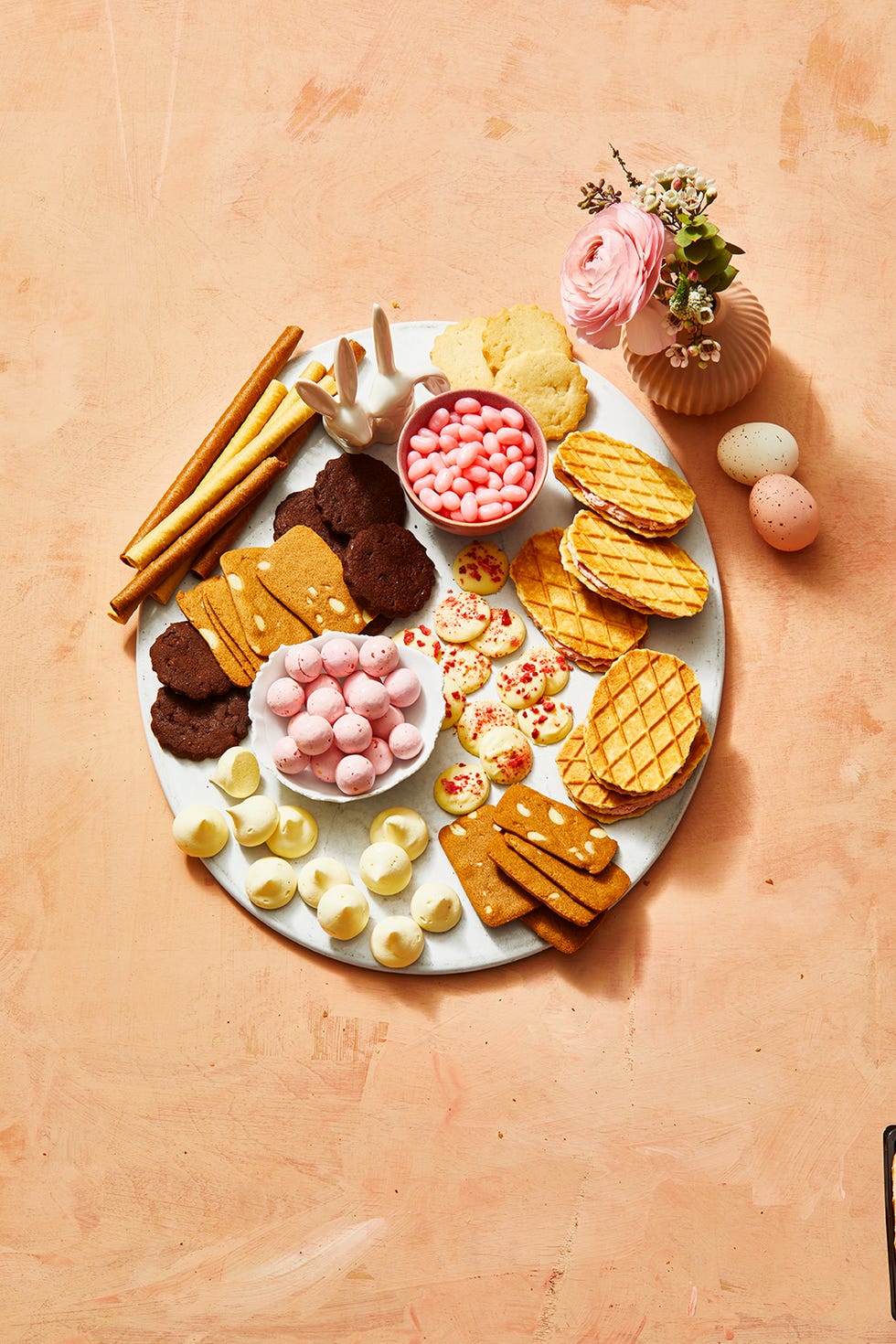 snack board with cookies, chocolates and spring candies
