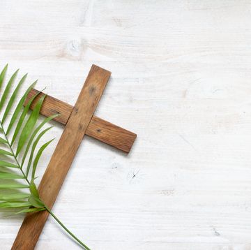 easter blessings and prayers cross and palm on wooden white background
