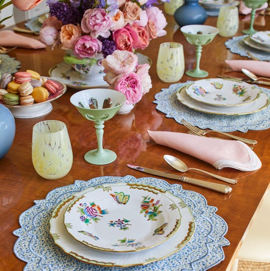 a table set for springtime with pretty plates and flowers