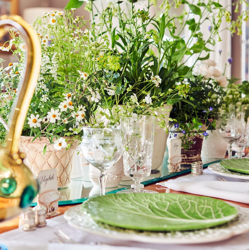 a table set with lettuce leaf plates and potted plants