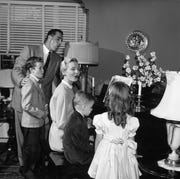 easter tradition - singing around the piano black and white photo of family carrying out easter tradition of singing songs around the piano