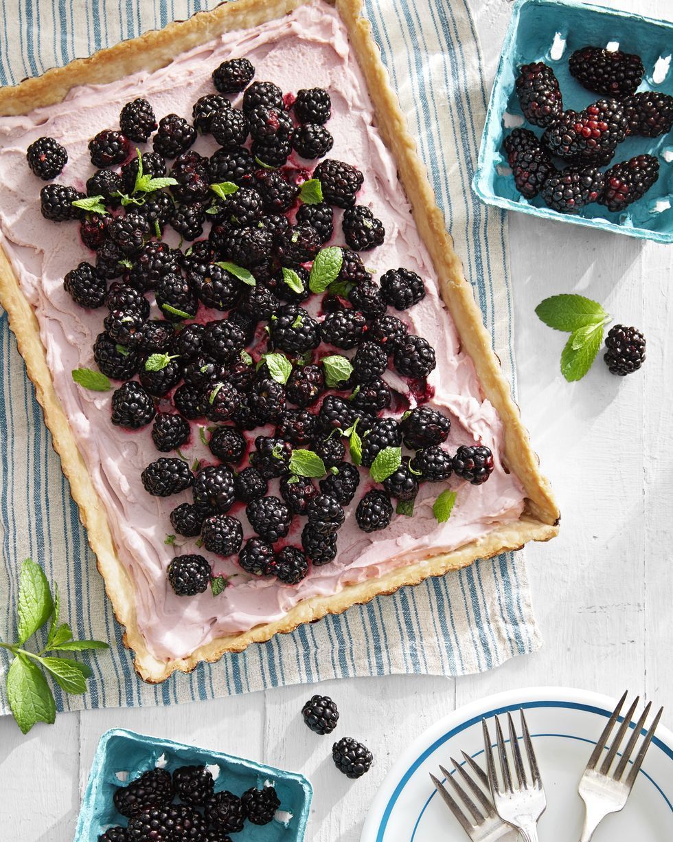 blackberry tart in a rectangle tart shell and topped with fresh blackberries and fresh mint leaves