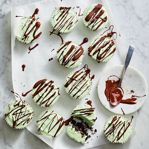 mint cupcakes with chocolate cake filled in the center and chocolate drizzled on top