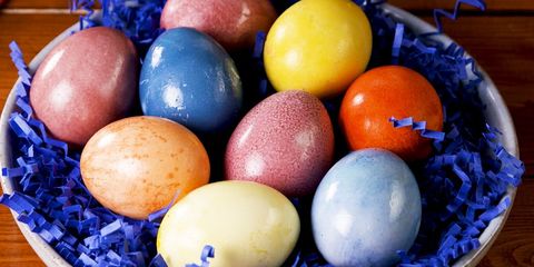 multicolored naturally dyed easter eggs on blue crinkle paper
