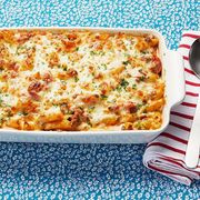 baked ziti on blue surface with red and white napkin
