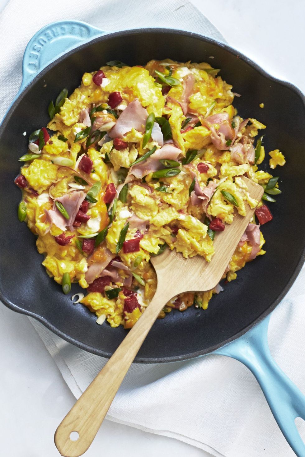 pimiento ham and cheese scramble in skillet with wooden spatula