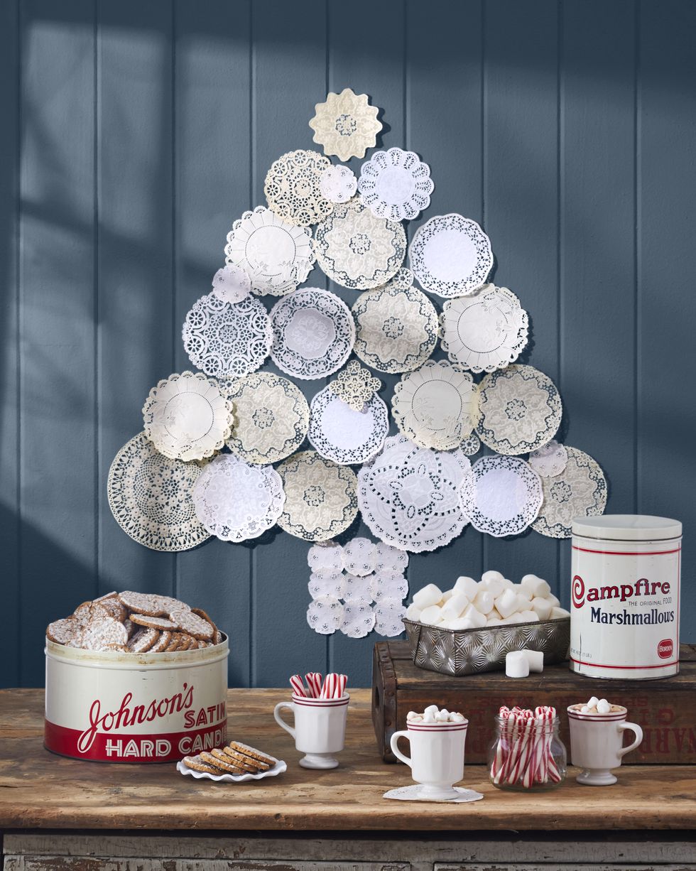 vintage doilies arranged on a blue wall in the shape of a christmas tree