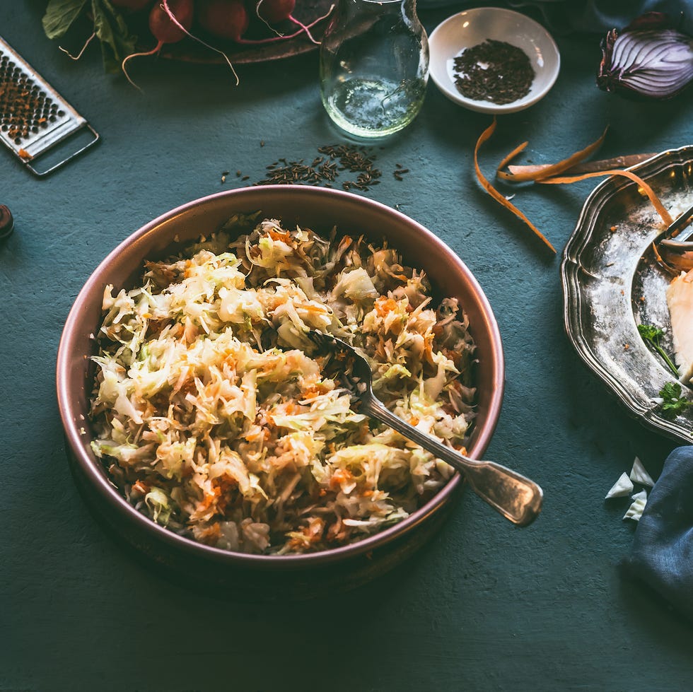 thanksgiving traditions - Easy Cole Slaw cabbage salad on kitchen table with ingredients thanksgiving traditions easy cole slaw cabbage salad on kitchen table with ingredients