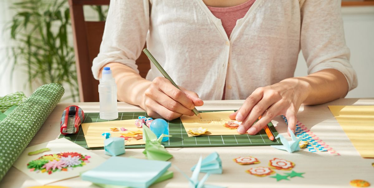 woman doing simple craft at wooden table