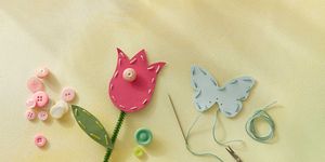 punch paper flowers and butterflies that are stitched with thread