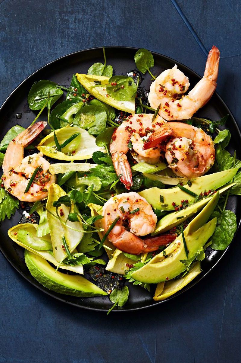shrimp and watercress salad on a black plate
