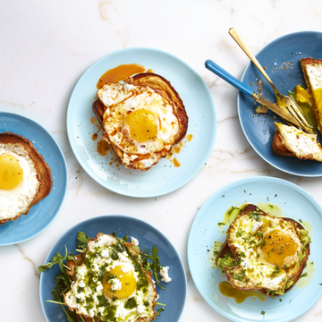 several blue plates with a variety of egg toasts