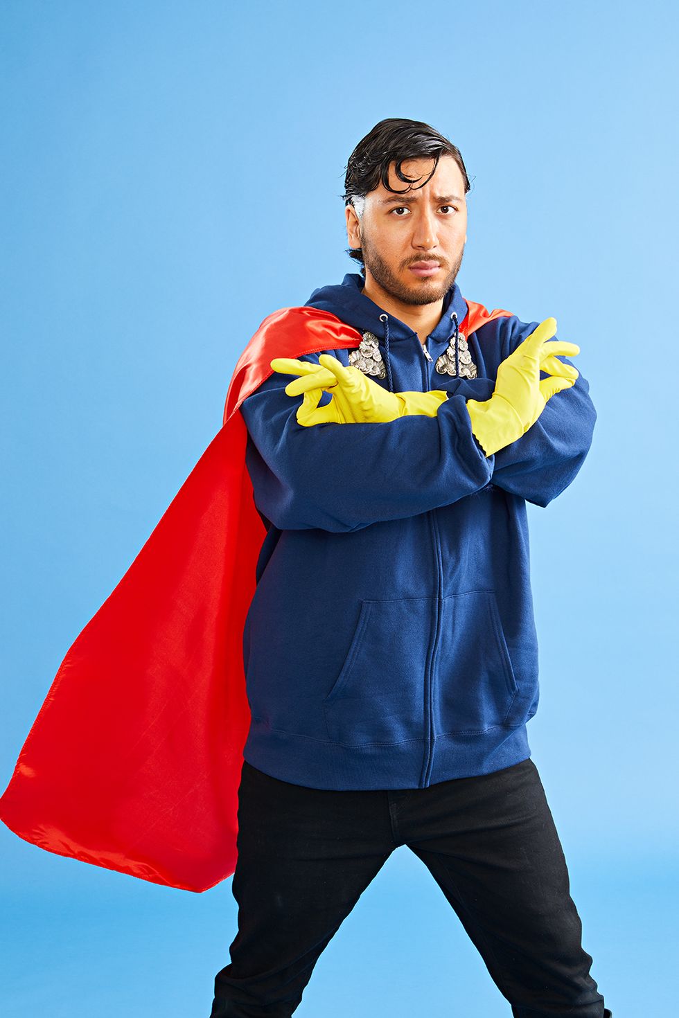 easy halloween costume man dressed with a red cape and blue sweater and black jeans