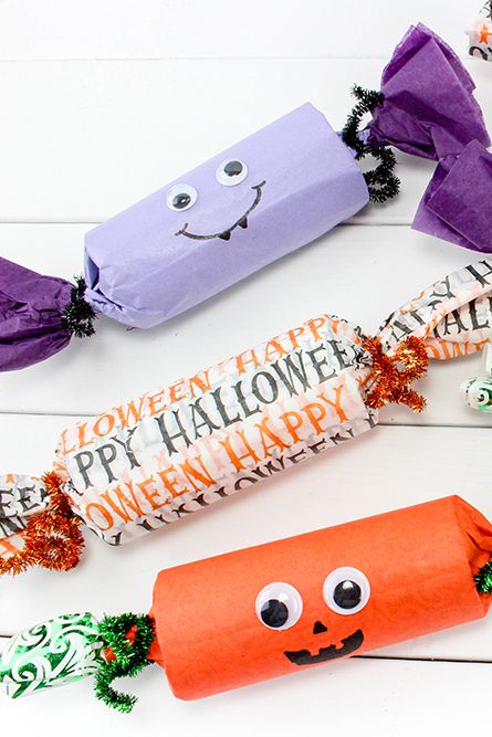 easy party popper halloween craft for kids made with toilet paper rolls, colorful tissue paper, and sparkly pipe cleaners