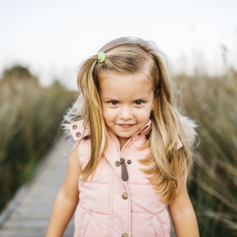 portrait of smiling little girl in nature